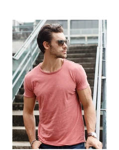 Outdoor shot of men's slim fit slub cotton t-shirt in coral pink with textured detail