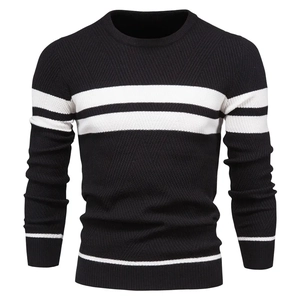 Detail of knitted crewneck sweater showing black and white striped pattern and fine texture