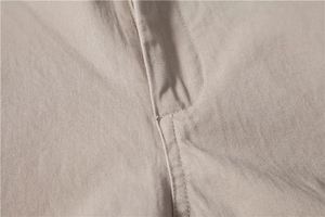 Detail shot of khaki casual trousers showing twill cotton texture and premium stitching