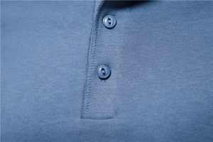Close-up of buttons and knitting texture on a navy blue casual long sleeve shirt