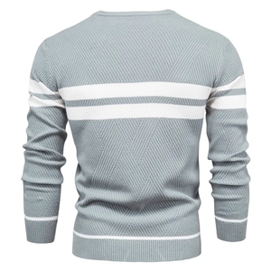 Detail of the grey knitted sweater featuring horizontal white stripes and ribbed texture