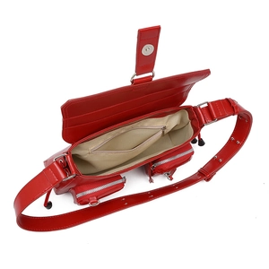 Top view of red faux leather shoulder bag showing main compartment and silver zippers