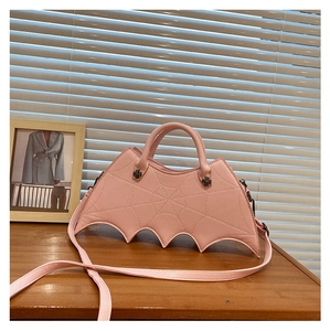 Pink bat-winged handbag with spiderweb stitching detail and detachable crossbody strap