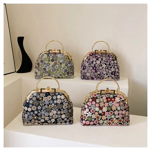 Detailed close-up of shell-shaped frame bags with vintage floral patterns and metal clasps