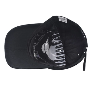 Detail view of cotton baseball cap interior featuring white brand label and adjustable strap