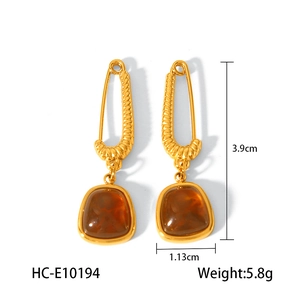 Detail view of gold-plated earrings with amber stones showing size measurements and weight
