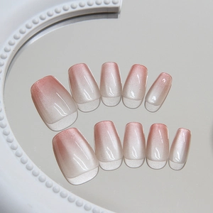 Pink and white gradient cat-eye press-on nails set with shimmer effect on round mirror