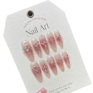 Pink gradient press-on nails with sparkling rhinestones and pearls on almond shapes