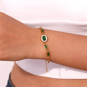 Detailed view of 18K gold plated bracelet with green oval stones and white zircon micro-paving