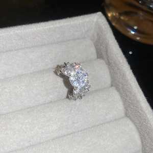 Close-up of wide silver ring with multi-row sparkling zircon insets on jewelry box