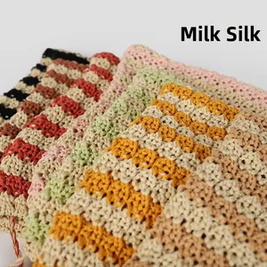 Detailed view of colorful striped milk silk crochet fabric with handmade texture
