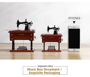 Macro detail of vintage sewing machine music boxes with faux wood grain and metal parts
