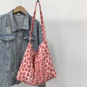 Detail of pink leopard print canvas tote bag featuring large capacity and stylish patterns