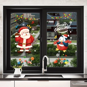 Christmas window stickers with Santa and penguins on kitchen glass for festive decoration