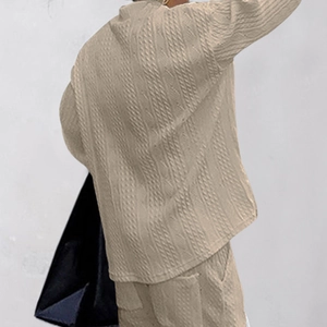 Detailed back view of khaki knitted suit showing chunky cable knit texture and relaxed fit