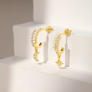 Detailed close-up of S925 silver gold-plated C-shaped earrings with pearls and stars