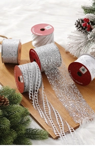 Detailed view of silver Christmas ribbons with glitter and mesh texture for festive decor