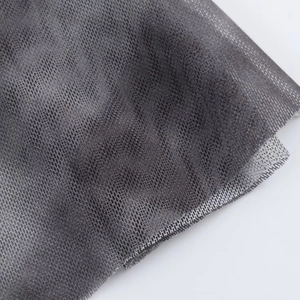 Macro shot of dark grey fine mesh fabric showing delicate net texture and layered tulle