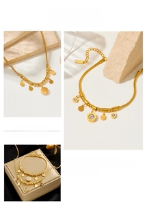 Detail of luxury gold snake chain jewelry set with zircon Roman numeral pendants
