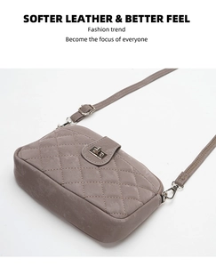 Detail of grey quilted leather phone crossbody bag with silver turn-lock and stitching