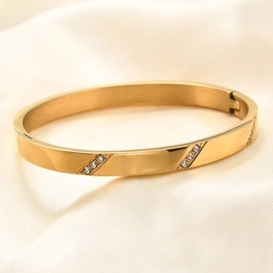 Macro shot of 18K gold plated stainless steel bangle with slanted inset diamonds