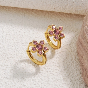 Detail of gold floral hoop earrings featuring purple and pink crystal petal charms