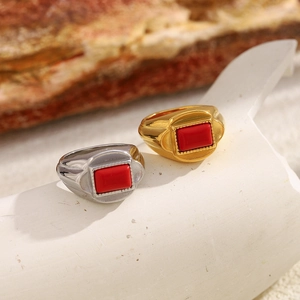 Detailed view of vintage 18K gold and silver rings featuring a rectangular red stone inlay