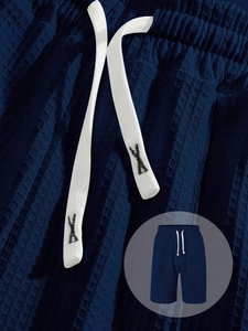 Detail of navy blue waffle texture fabric and white cotton drawstring on men shorts