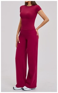 Front view of a dark red brushed yoga set featuring short sleeve top and flare leg pants