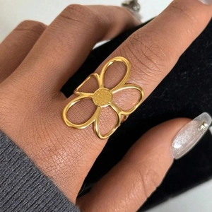 Minimalist gold hollow flower ring in stainless steel with textured petal details