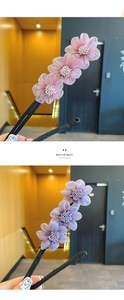Close-up of elegant floral hair pins with pink and purple mesh petals and pearl centers