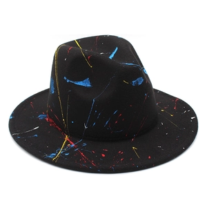 Detail of colorful paint splatter graffiti on a black felt fedora hat with wide brim