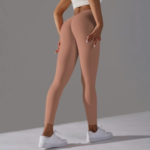 Detail view of the V-waist and ruched butt lifting seam on brown yoga leggings