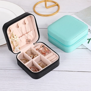 Portable square jewelry box in black and mint green with zipper and cross pattern leather