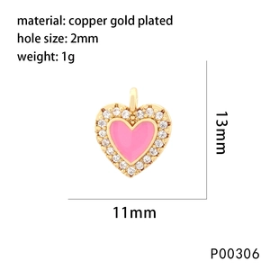 Macro shot of 13mm gold plated heart pendant with pink enamel and zircons for jewelry making