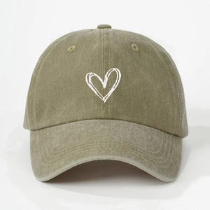 Olive green washed cotton baseball cap with white embroidered heart on a plain background