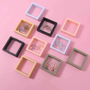 Colorful floating PE film jewelry boxes for rings and necklaces on pink background