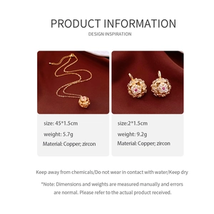 Detail view of vintage gold necklace and earrings set with red and white zircons