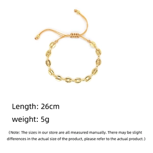 Detail of gold bean charm on beige woven bracelet showing adjustable slider and 26cm length