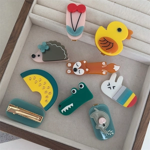Cute animal and fruit acetate duckbill hair clips for women in a display tray