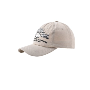 Macro detail of Dolphin Hotel embroidery on beige cotton vintage baseball cap