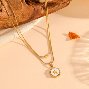 Detail of 18K gold-plated double-layer necklace with a white pendant and gold star