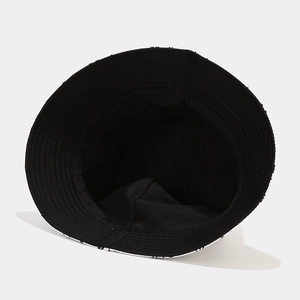Minimalist black cotton bucket hat with parallel stitched brim shown from an overhead view