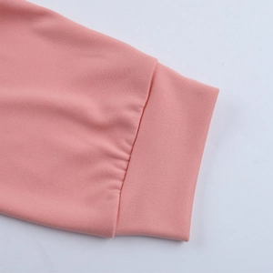 Detail of soft pink knitted sleeve cuffs with ribbed design and fine texture close-up