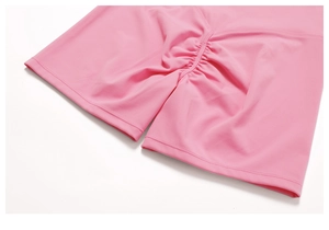 Close-up of the scrunch butt detail on pink high-waisted yoga shorts with matte texture