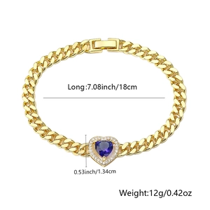 Detail of gold-plated Cuban link bracelet with a micro-pave heart blue stone