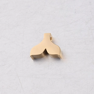 Macro view of gold mirror titanium steel mermaid tail pendant with hole for DIY jewelry