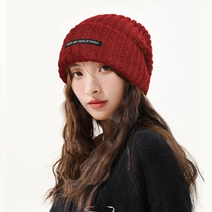 Red knit slouchy beanie for women shown on model for a trendy autumn and winter style