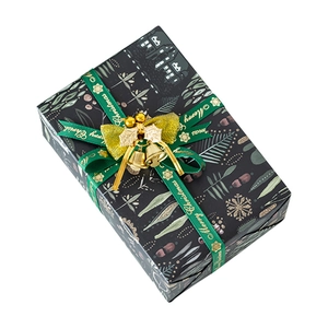 Christmas gift box with snowflake patterns, green Merry Christmas ribbon and golden bell