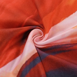 Macro view showing abstract gradient print texture on soft knit bodycon dress fabric